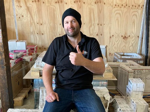 Hayden Wright with thumbs up surrounded by tiles