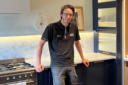 Manson Jenkins in the Orchard Joinery showroom leaning on the kitchen bench