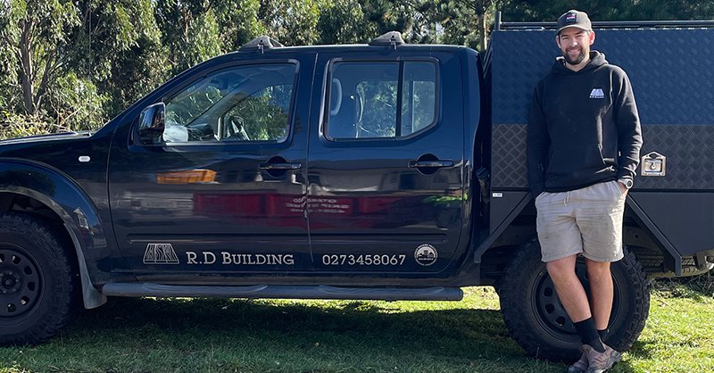 Ryan Duffy standing beside his work vehicle